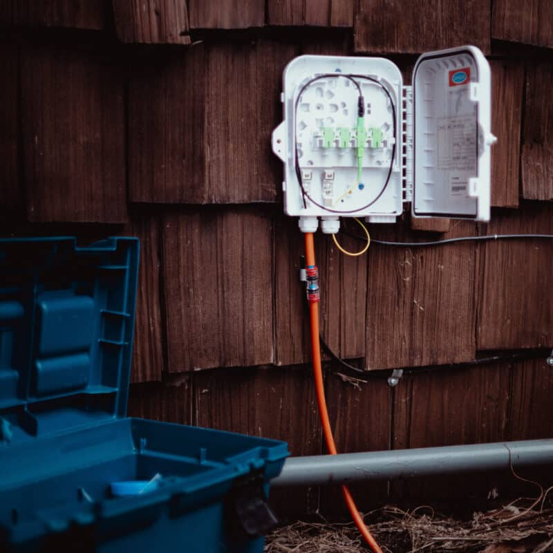 Fiber optic cable box on the side of the home