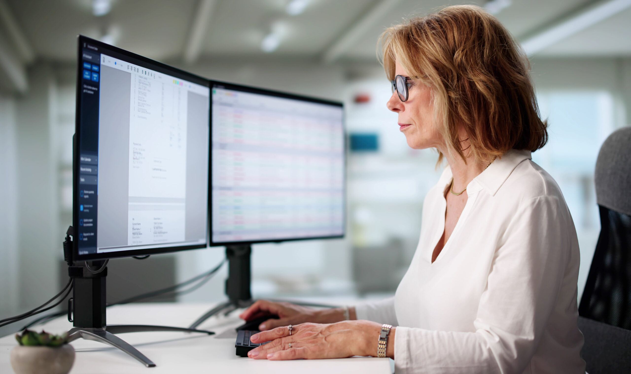 Woman Using Software To Manage Invoices In Home Office.