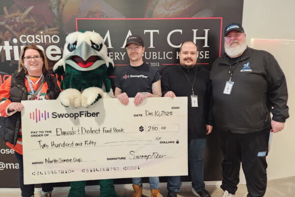 5967116079237987843 SwoopFiber team holding a large foodbank donation check